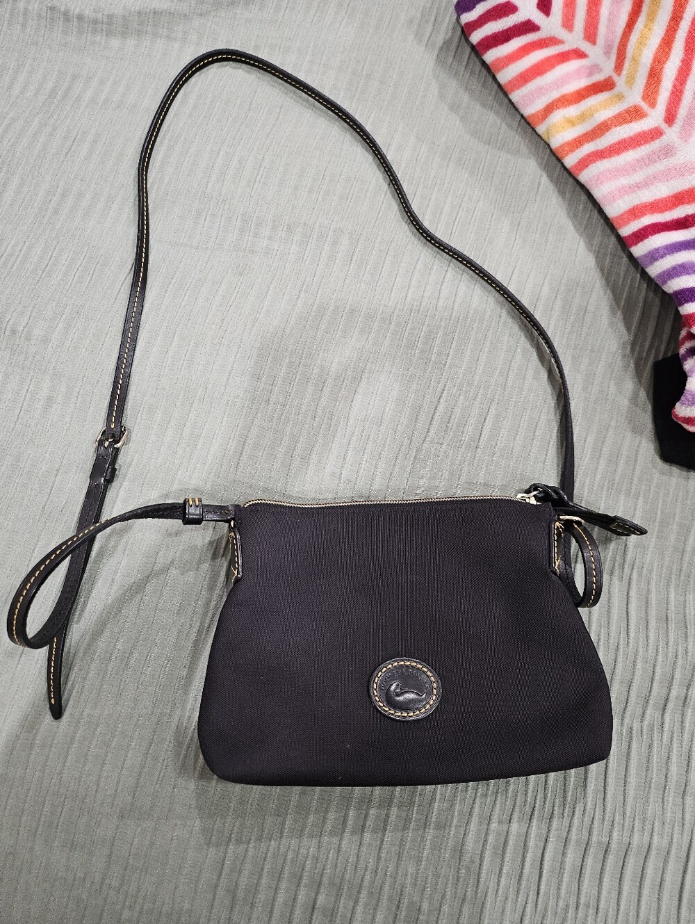 Dooney & Bourke Nylon Crossbody Pouchette with leather trim.